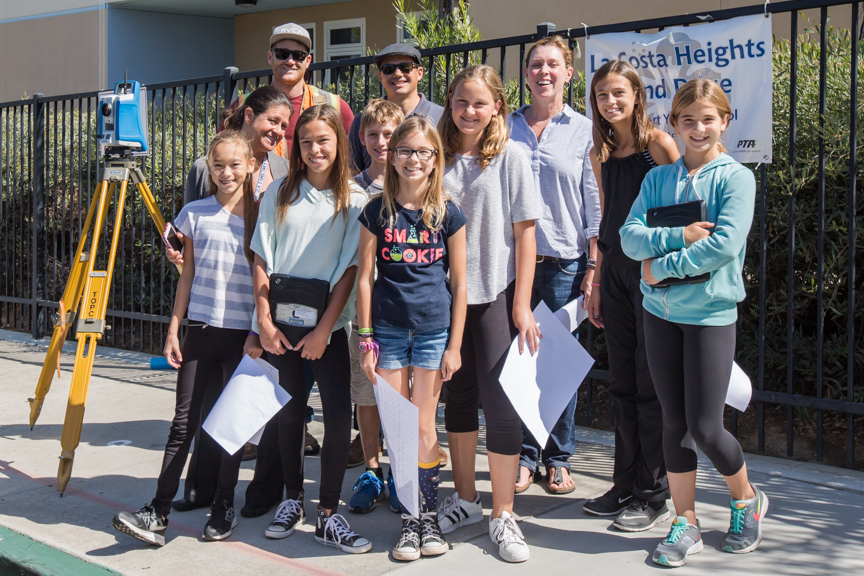 Group of elementary school interns from La Costa Heights with a survey team and civil engineer preparing for the on campus water quality project